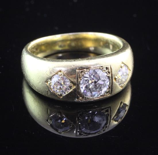 A gentlemans 18ct gold and gypsy set three stone diamond ring, size T.